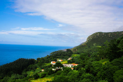 High angle view of sea and mountains against sky