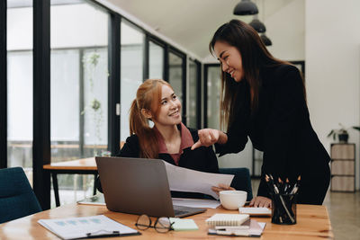 Businesswoman discussing with colleague at office