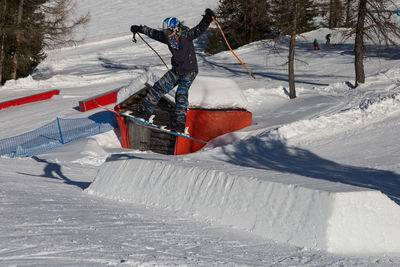 People skiing on snow covered field