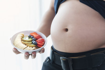 Midsection of woman holding ice cream