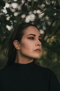 Young woman lookinhg away standing outdoors