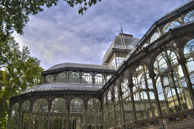 Low angle view of old building against cloudy sky