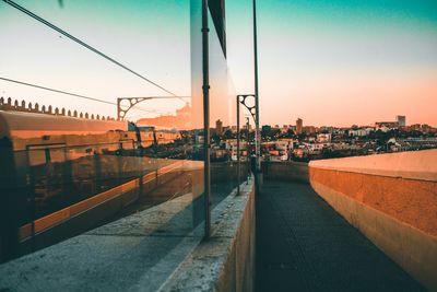 View of street and buildings against sky during sunset