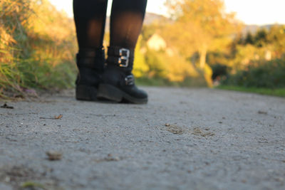 Low section of person standing on road