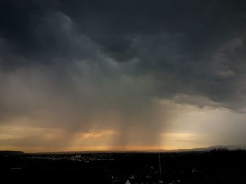 Dramatic sky over silhouette landscape during sunset