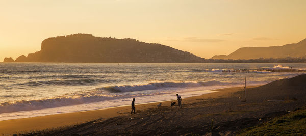 Scenic view of beach against sky during sunset