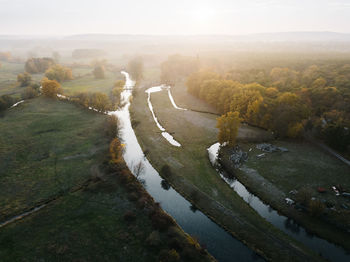 High angle view of road by trees against sky
