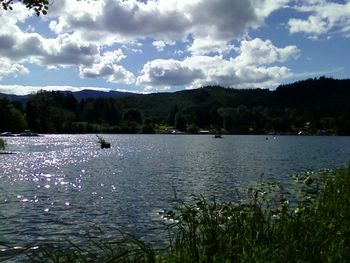 Scenic view of lake against cloudy sky