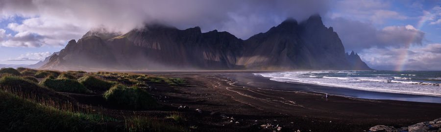 Panoramic view of sea and mountains against sky