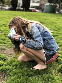 Midsection of woman wearing hat on field