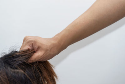 Close-up of woman hand over white background