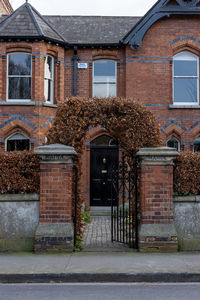 Exterior of house by building in city