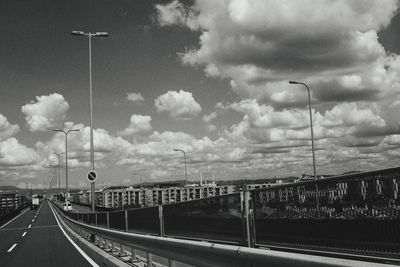 Street by highway against sky