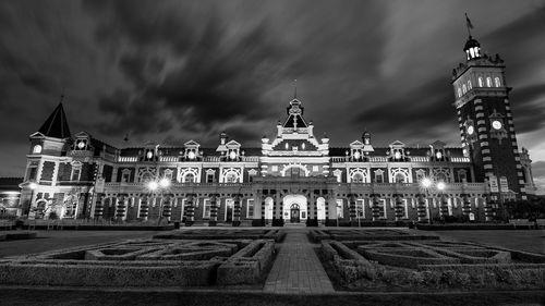 Buildings in city against cloudy sky