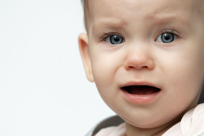 Close-up of cute boy against white background