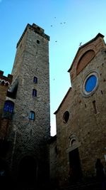 Low angle view of building against clear blue sky