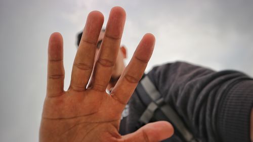 Close-up of human hand against white background