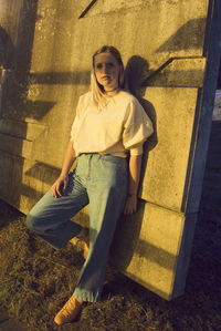 Portrait of smiling young woman standing on floor