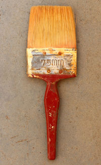 High angle view of various paint on shelf against white background