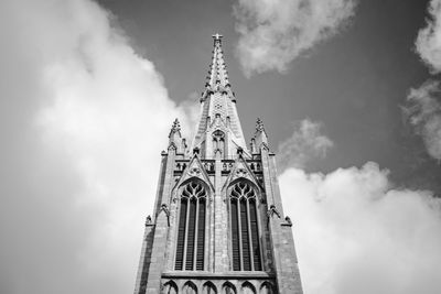 Low angle view of building against cloudy sky