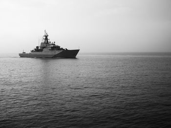 Ship sailing on sea against sky