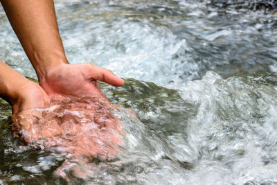 Midsection of man in water