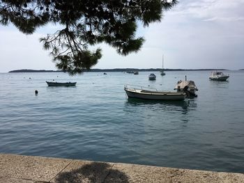 Boats in sea against sky