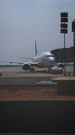 Airplane on runway against clear sky