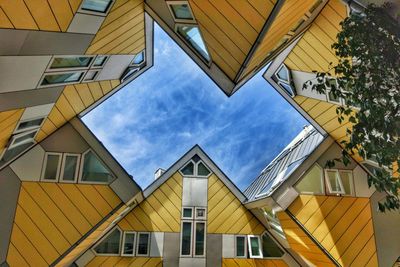 Low angle view of building against cloudy sky