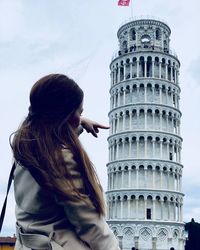 Woman standing by building