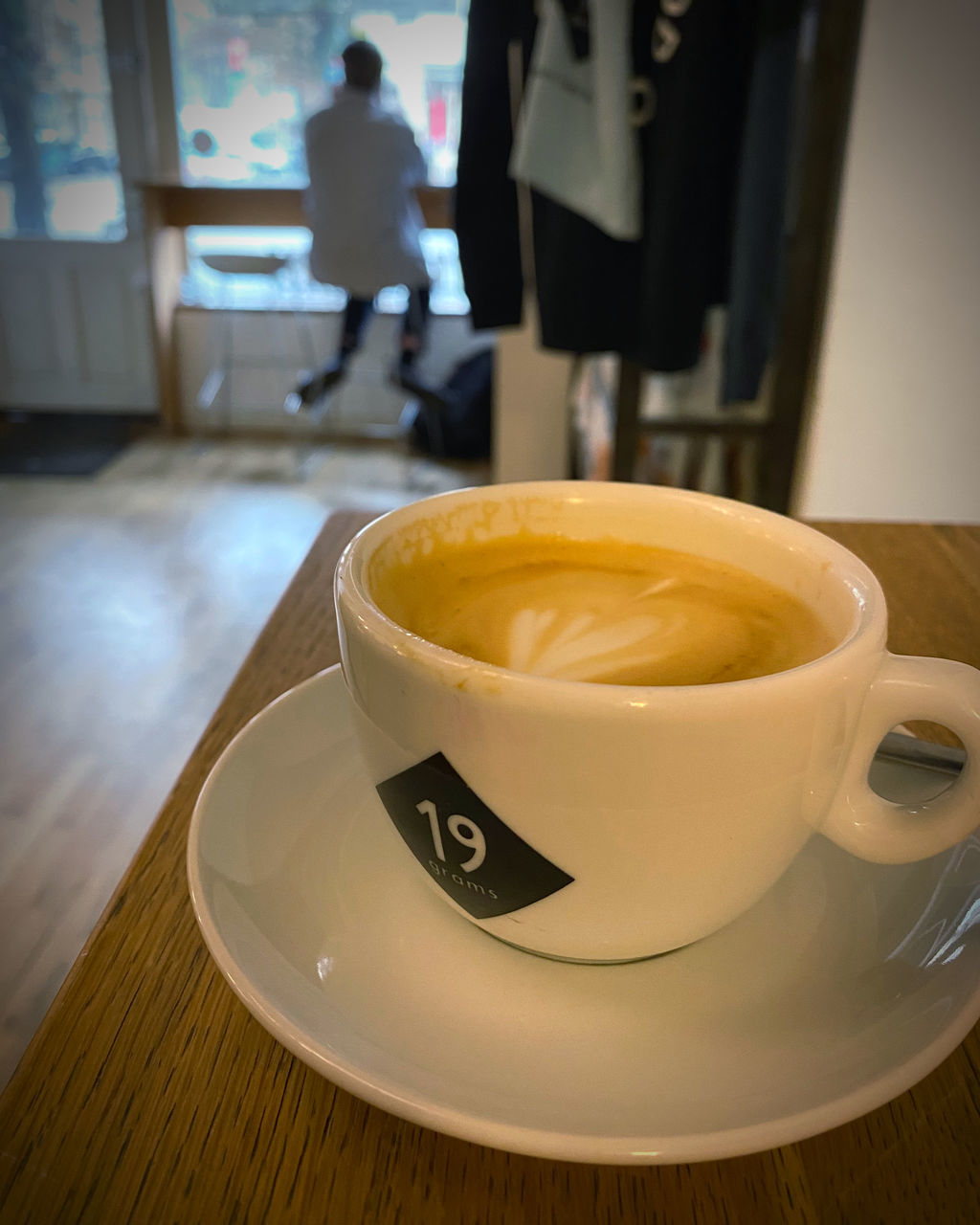 food and drink, drink, coffee, mug, cup, indoors, refreshment, coffee cup, business, table, cafe, hot drink, saucer, crockery, focus on foreground, food