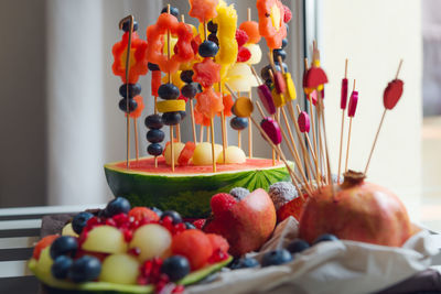 Fruit salad for a child's birthday. various fruits are put on toothpicks 