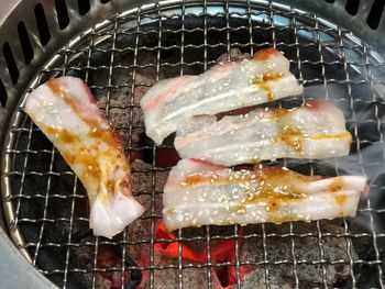 High angle view of meat on barbecue grill