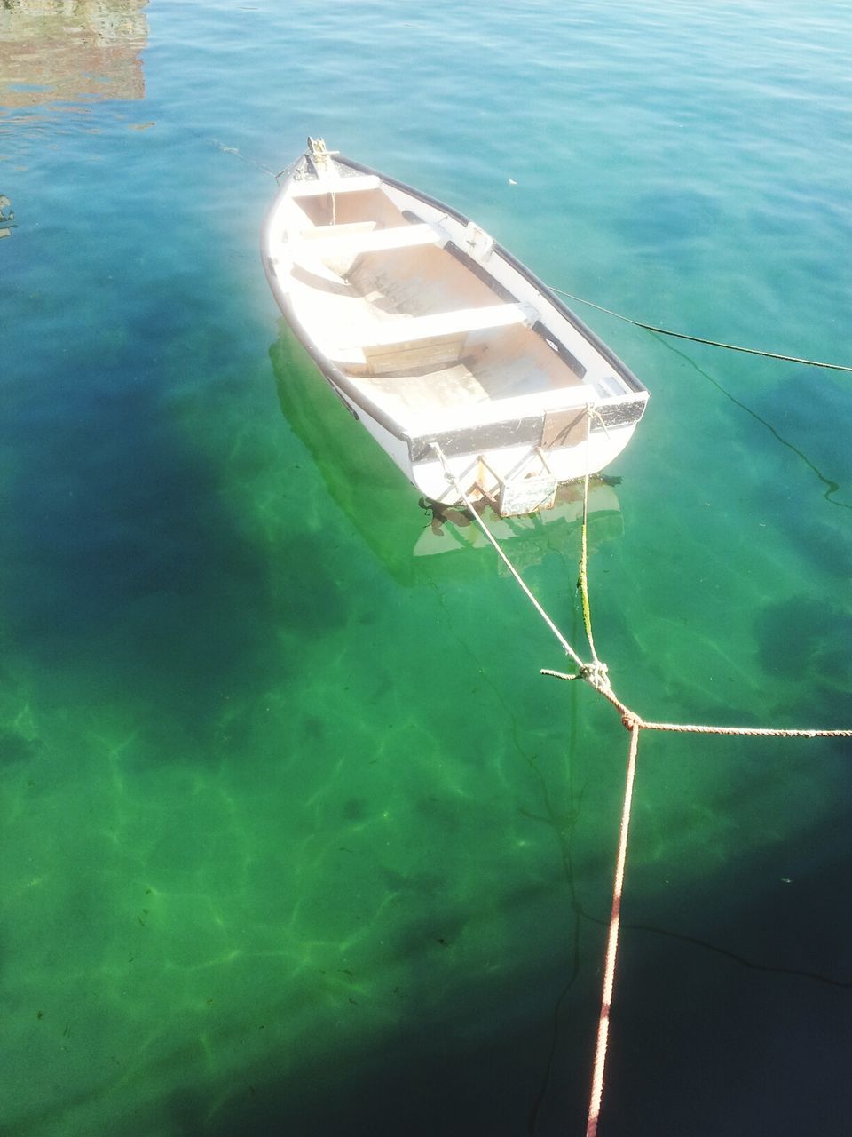 nautical vessel, water, boat, sea, transportation, moored, mode of transport, high angle view, rope, nature, tranquility, day, sailboat, rippled, waterfront, outdoors, no people, tranquil scene, blue, lake