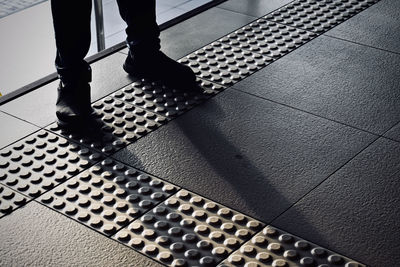 Low section of man standing on floor