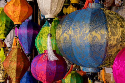 Multi colored umbrellas hanging for sale at market stall