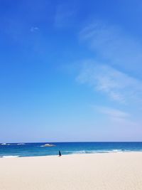 Scenic view of beach against blue sky