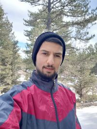 Portrait of man standing in snow