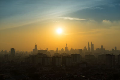 Cityscape against sky during sunset