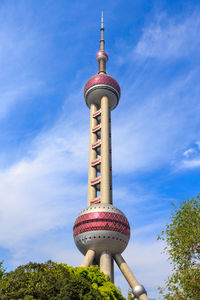 Low angle view of communications tower against blue sky