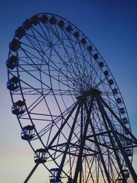 Low angle view of ferris wheel against clear sky