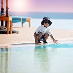 Portrait of happy girl playing on beach