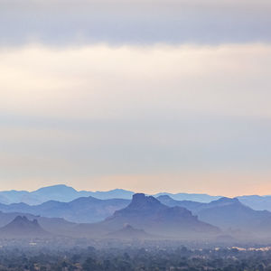 Scenic view of snowcapped mountains against sky during sunset