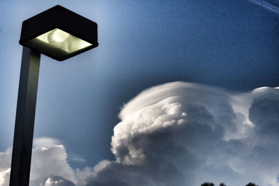 Low angle view of illuminated street light against sky
