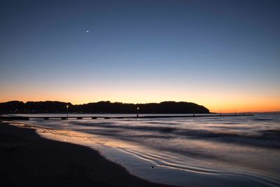 Scenic view of sea against clear sky during sunset