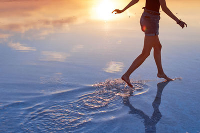 Close up of woman running on the beach at sunset person