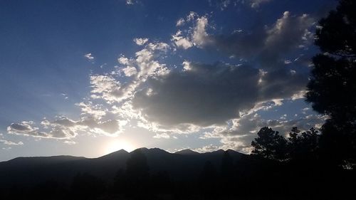 Scenic view of silhouette mountains against sky at sunset