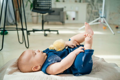 Baby girl lying on a light fabric in the studio. high quality photo