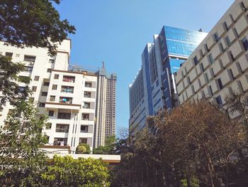 Low angle view of skyscrapers against clear sky