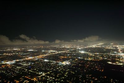 High angle view of illuminated buildings in city at night